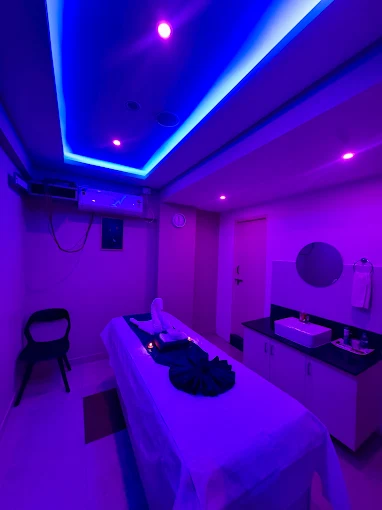 Massage bed and blue ceiling lighting at Sky Days Spa