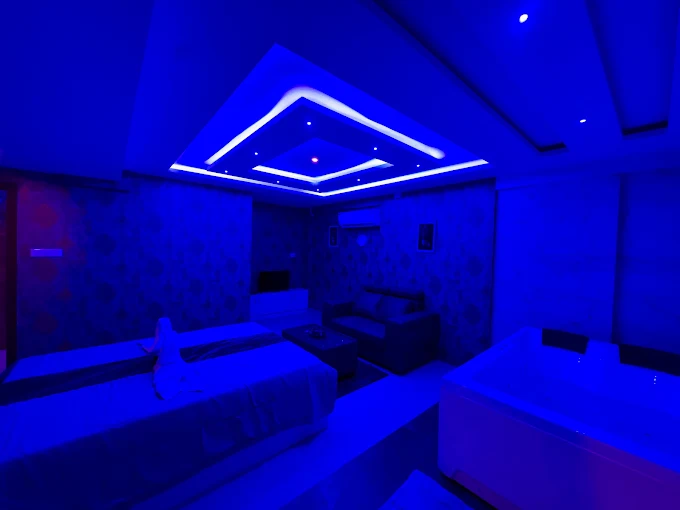 Treatment beds beneath blue ceiling lighting at Sky Days Spa