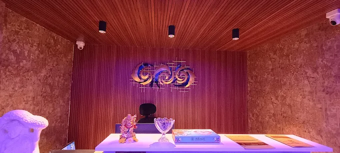 Sky Days Spa reception counter beneath a wood-panelled ceiling