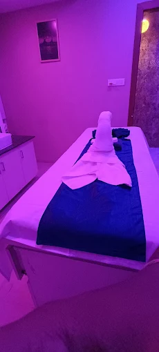 Folded towels on a massage bed at Sky Days Spa