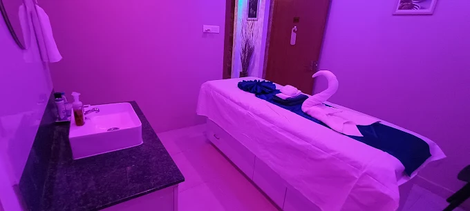 Massage table and folded towels inside a Sky Days Spa treatment room